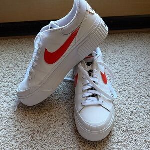 Like new Nike kicks with orange swoosh and leopard tongue